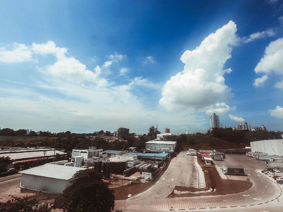 Aerial photograph showcasing a modern industrial area with buildings and clear skies, perfect for urban themed projects. Aerial photograph showcasing a modern industrial area with buildings and clear skies, perfect for urban themed projects.